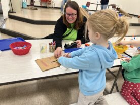 Young child practicing fine motor skills through play