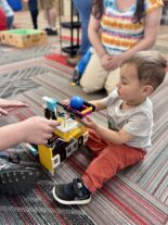 Child using tweezers and pom-poms during fine motor play