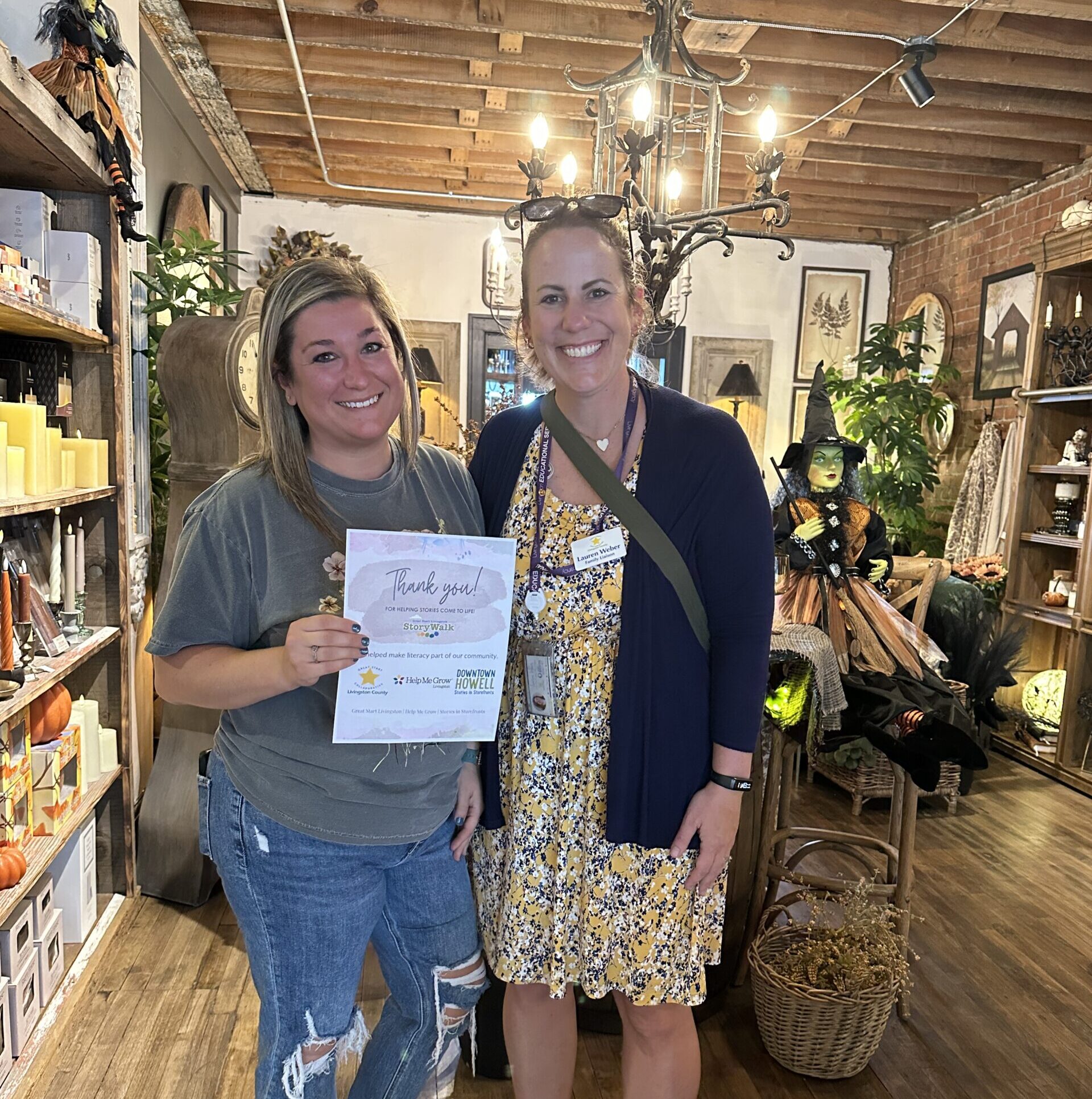 Great Start Livingston thanking a Stories in Storefronts host at Simply Charming in downtown Howell
