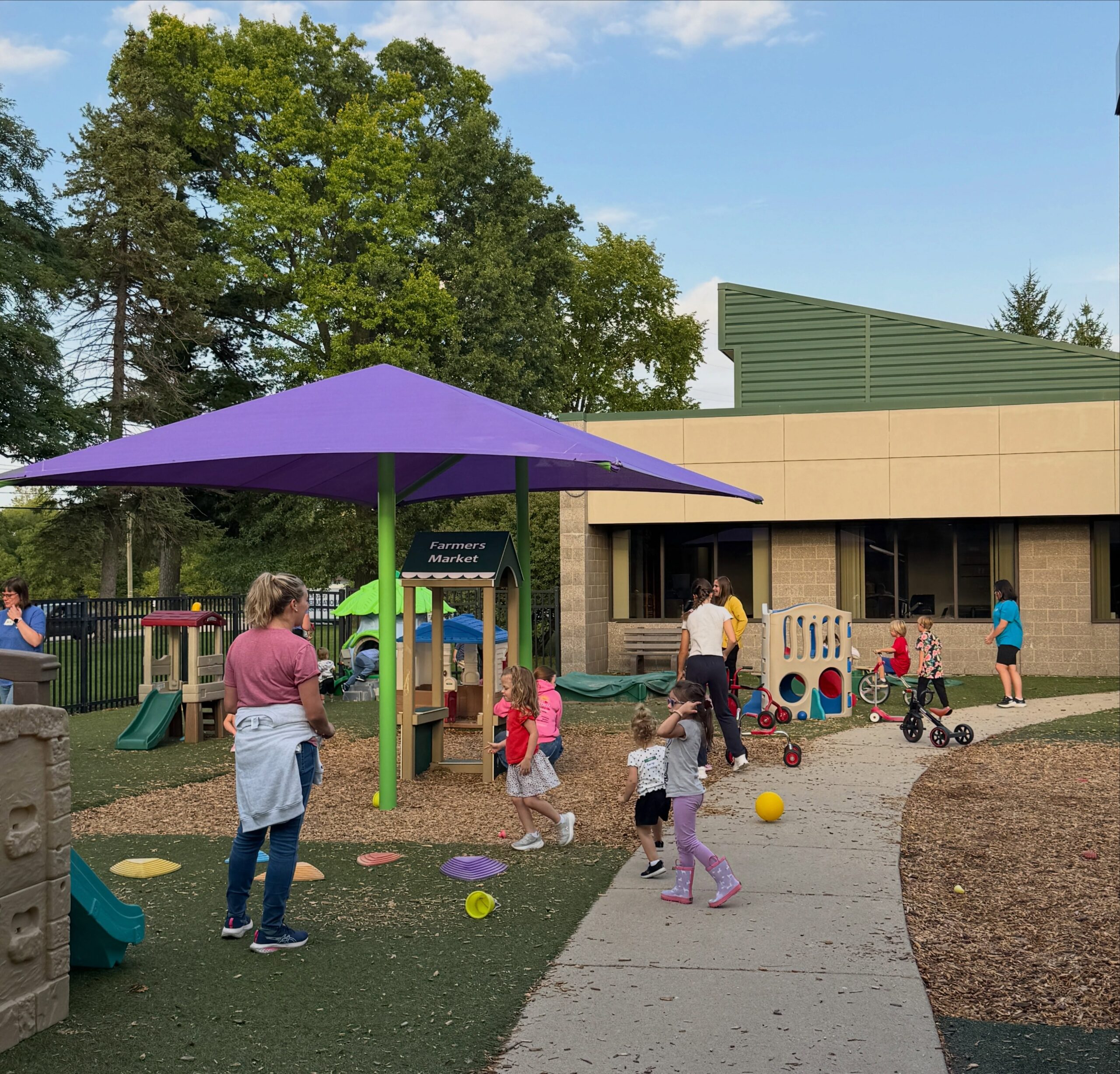 Children playing outside during childcare at a Great Start Livingston parent workshop in Howell Michigan